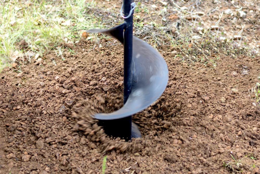 Construction auger digging hole
